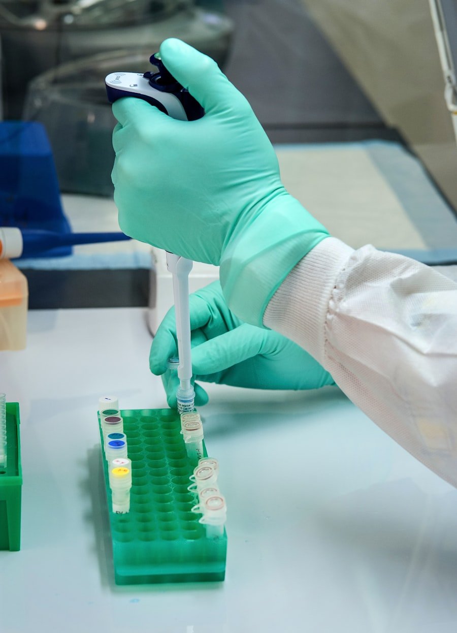 Technician using a pipettor over sample tubes